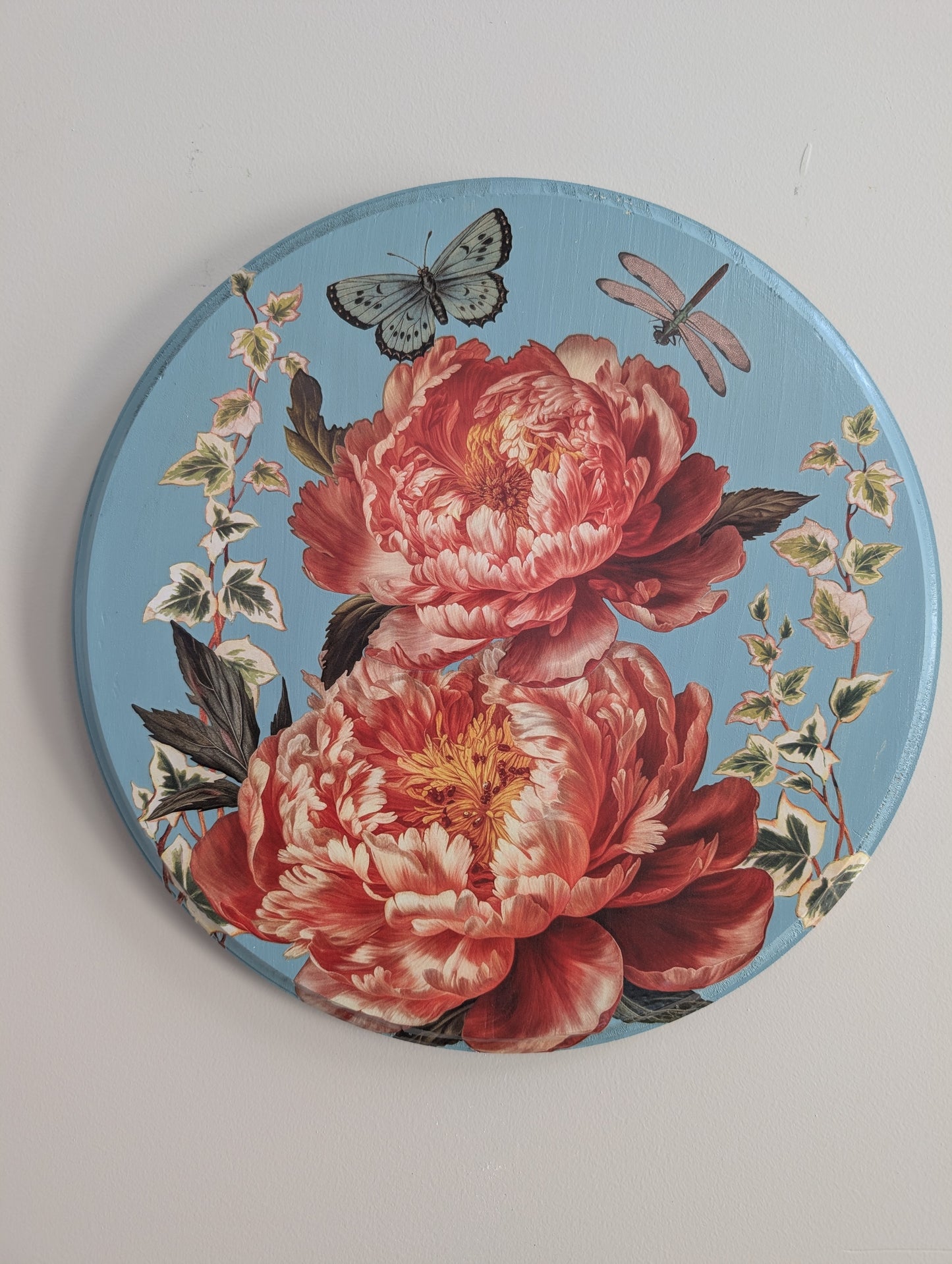 Decorative plate with floral design and butterflies on a light gray background