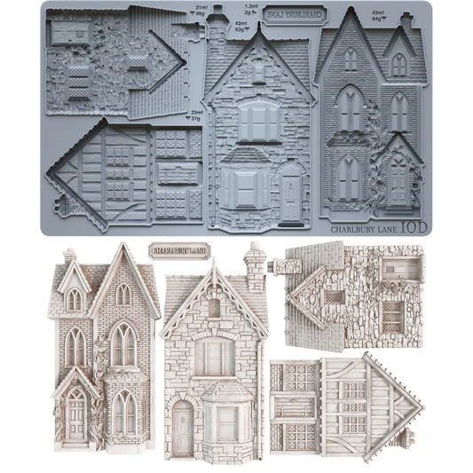 A set of miniature Victorian house templates and roof designs shown both assembled in gray and as unfolded paper/cardboard components on a white background. The text 'CHARLIE BAY LOND' and '10D' are visible on the gray assembled sheet.
