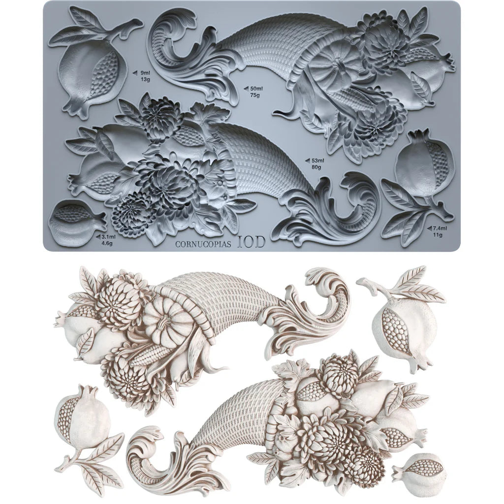 A 10D cornucopia mold shown in gray with its corresponding white 3D molded sample, featuring detailed floral, leaf, and pomegranate motifs on a white background.