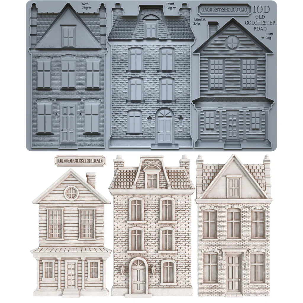 A set of miniature Victorian-style house molds and cutouts, including a gray metal mold tray at the top and three finished light beige house cutouts below on a white background.