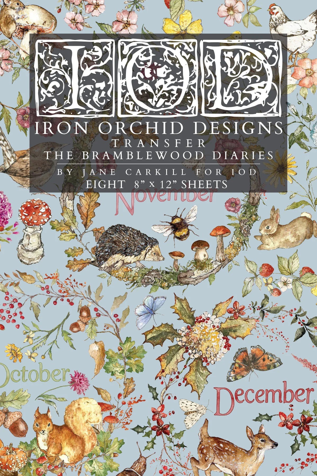 A flat lay of a transfer paper sheet featuring autumn and woodland illustrations, labeled 'IOD Iron Orchid Designs Transfer The Bramblewood Diaries' with months October, November, and December visible.