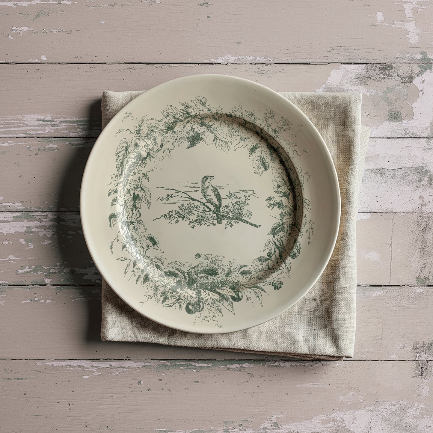 Decorative plate with bird and floral design on a textured surface