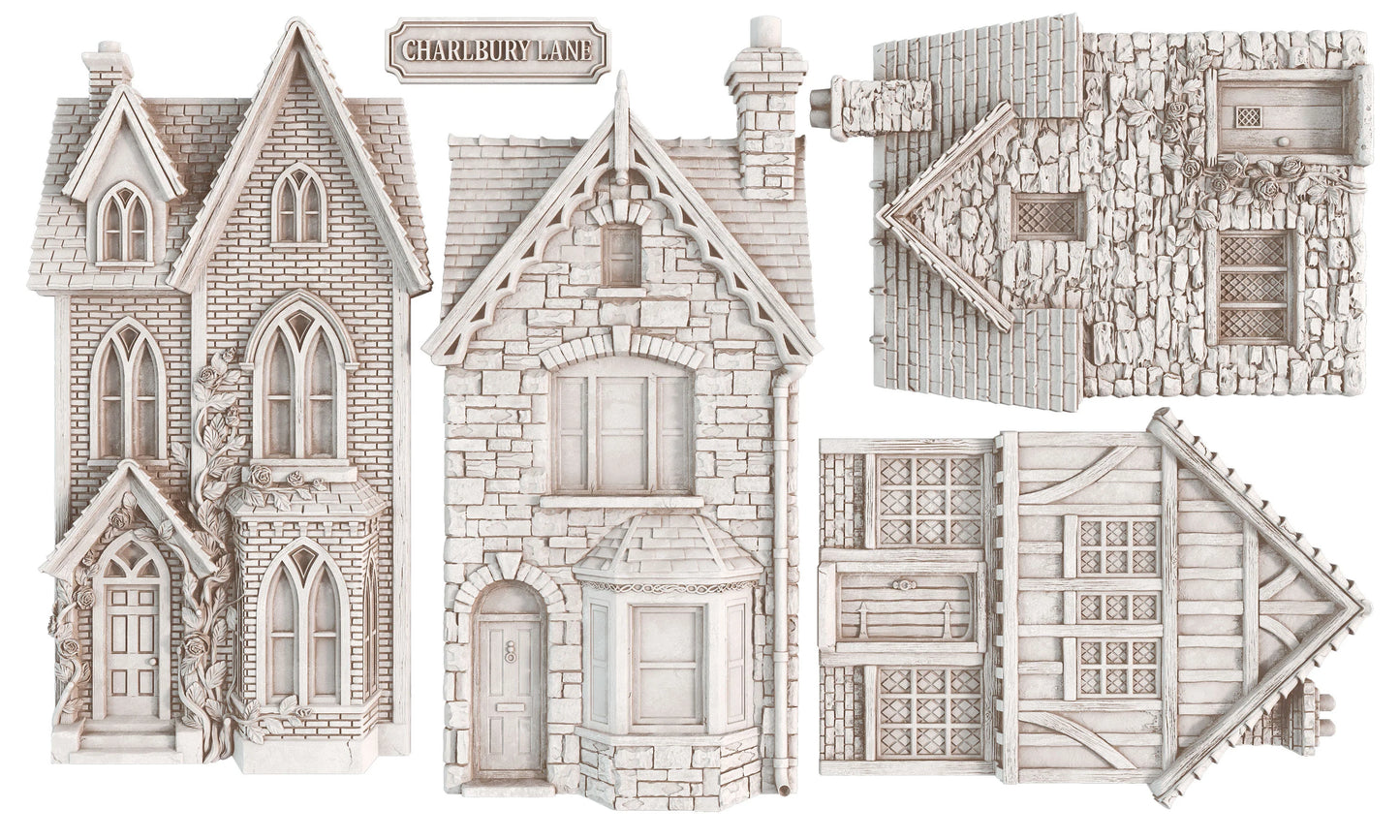 Four unpainted miniature plastic terrain pieces for tabletop wargaming, featuring a Victorian-style house, a cottage, and two timber-framed buildings in a light gray stone and wood finish.