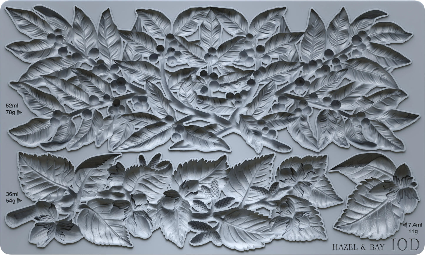 A gray silicone baking mold featuring a detailed relief pattern of hazelnuts, leaves, and berries, with printed dimensions and the brand name 'HAZEL & BAY' visible in the bottom right corner.