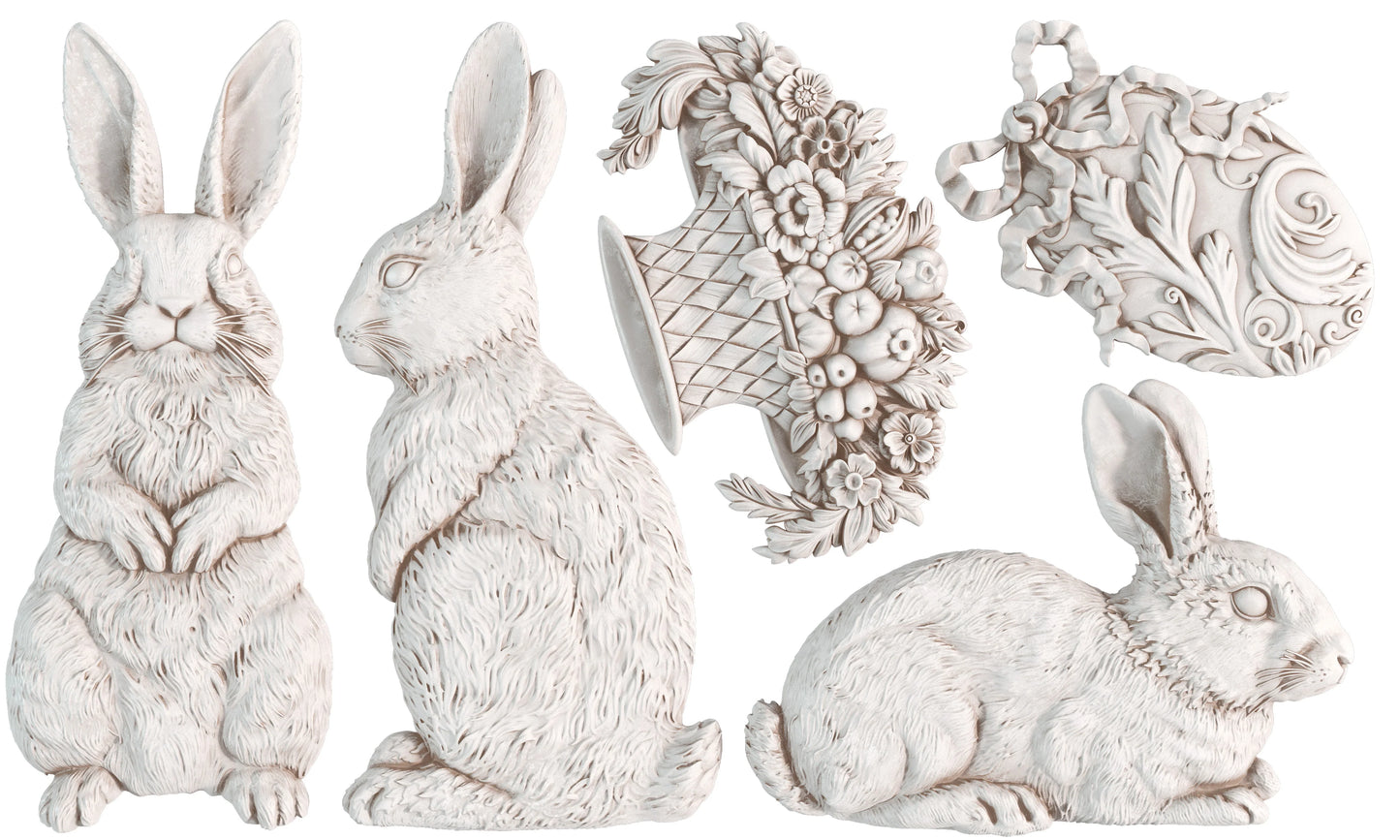 Set of decorative white rabbit figurines with intricate designs on a white background