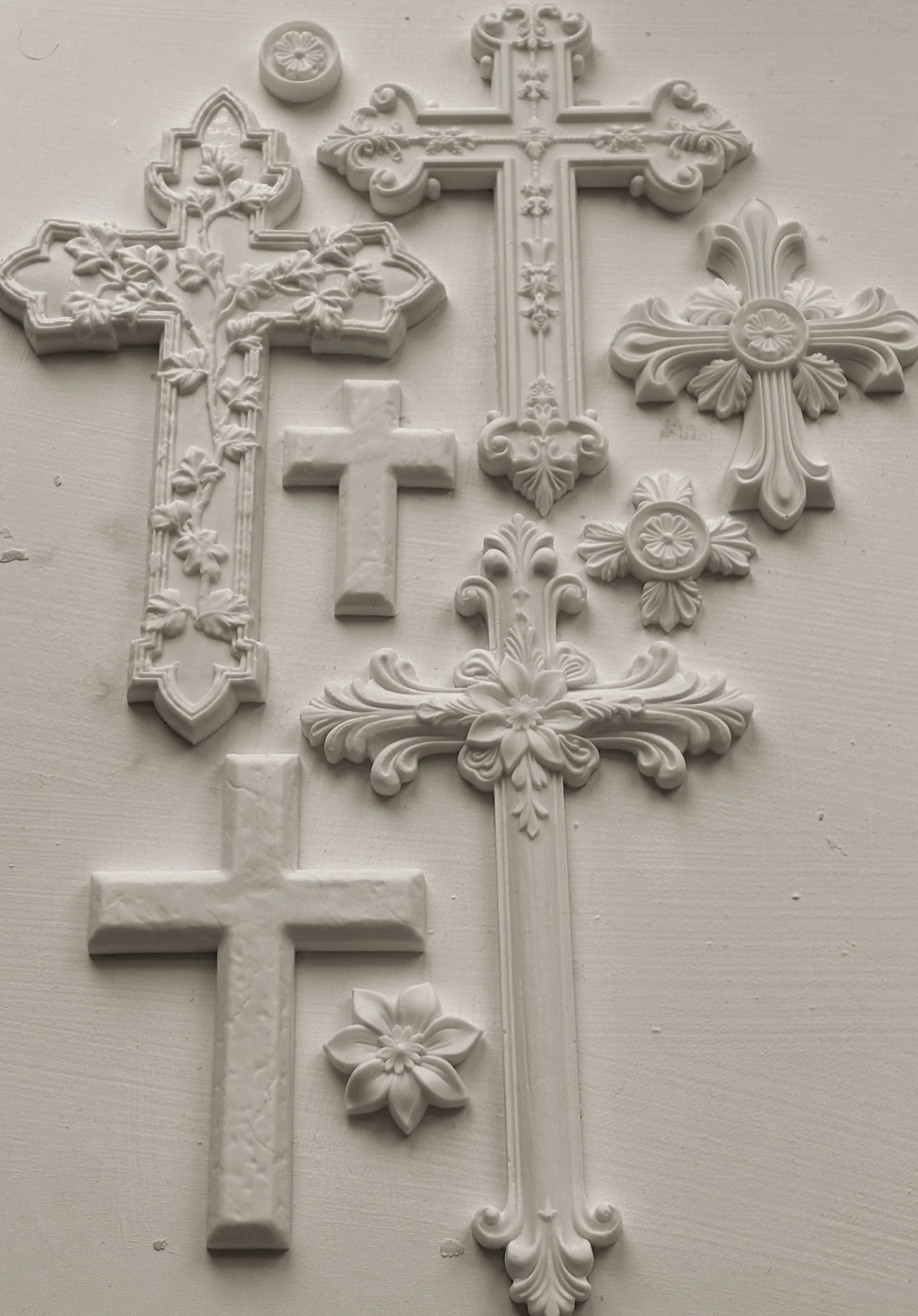 Decorative white crosses on a light gray background