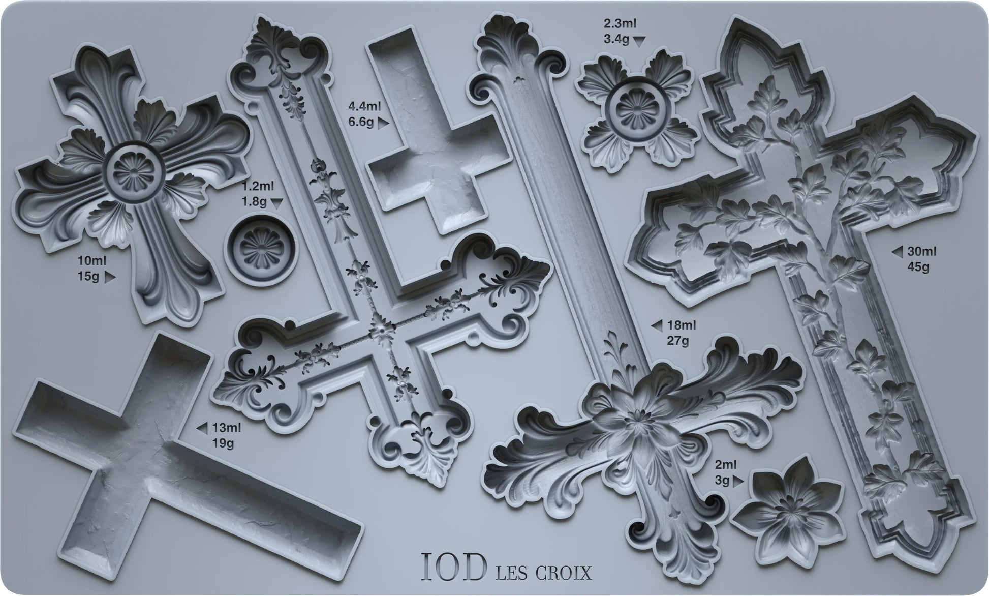 Decorative cross-shaped mold with measurements on a gray background