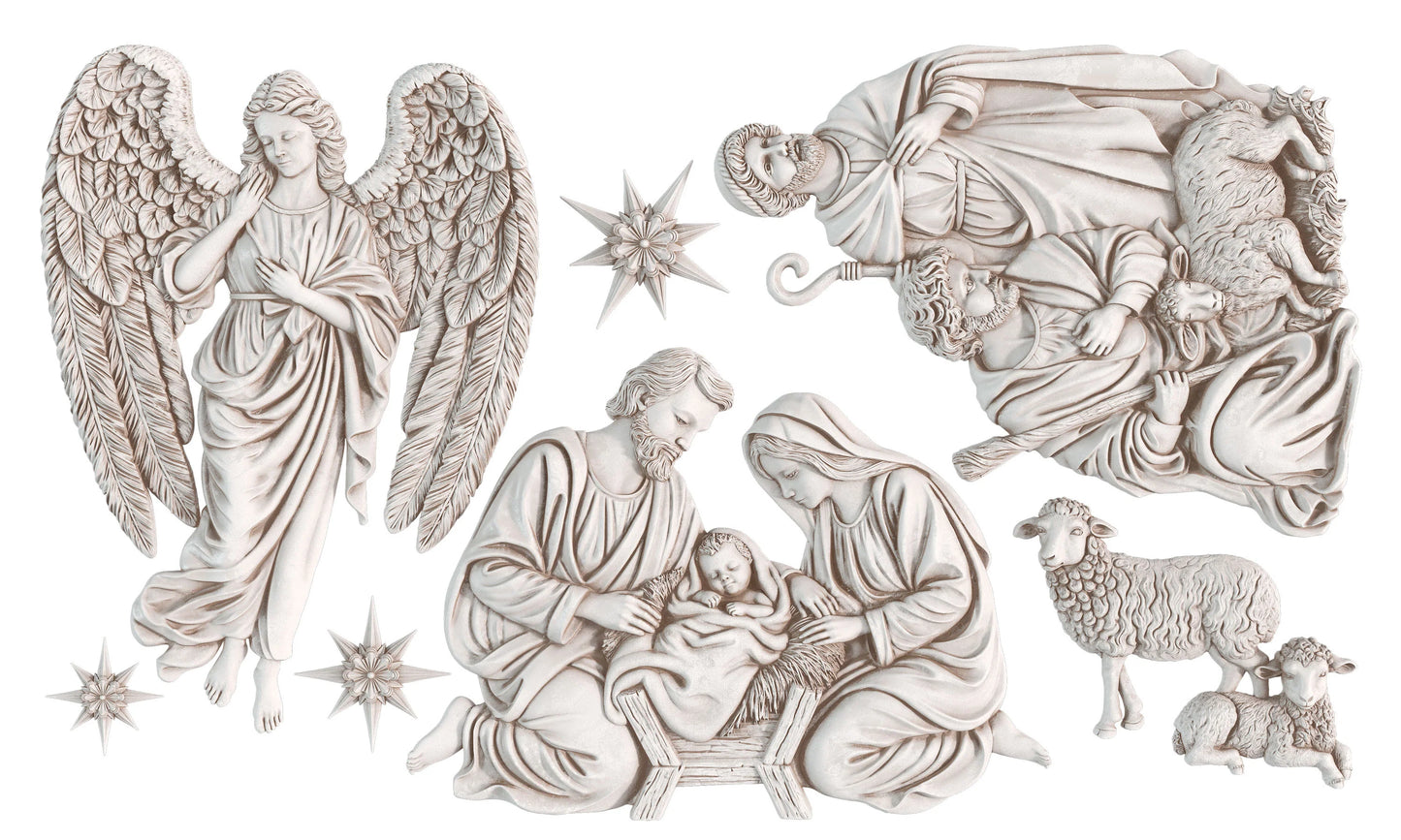 A set of white plaster or resin Christmas nativity figurines on a plain white background, including angels, the Holy Family, sheep, and star details.