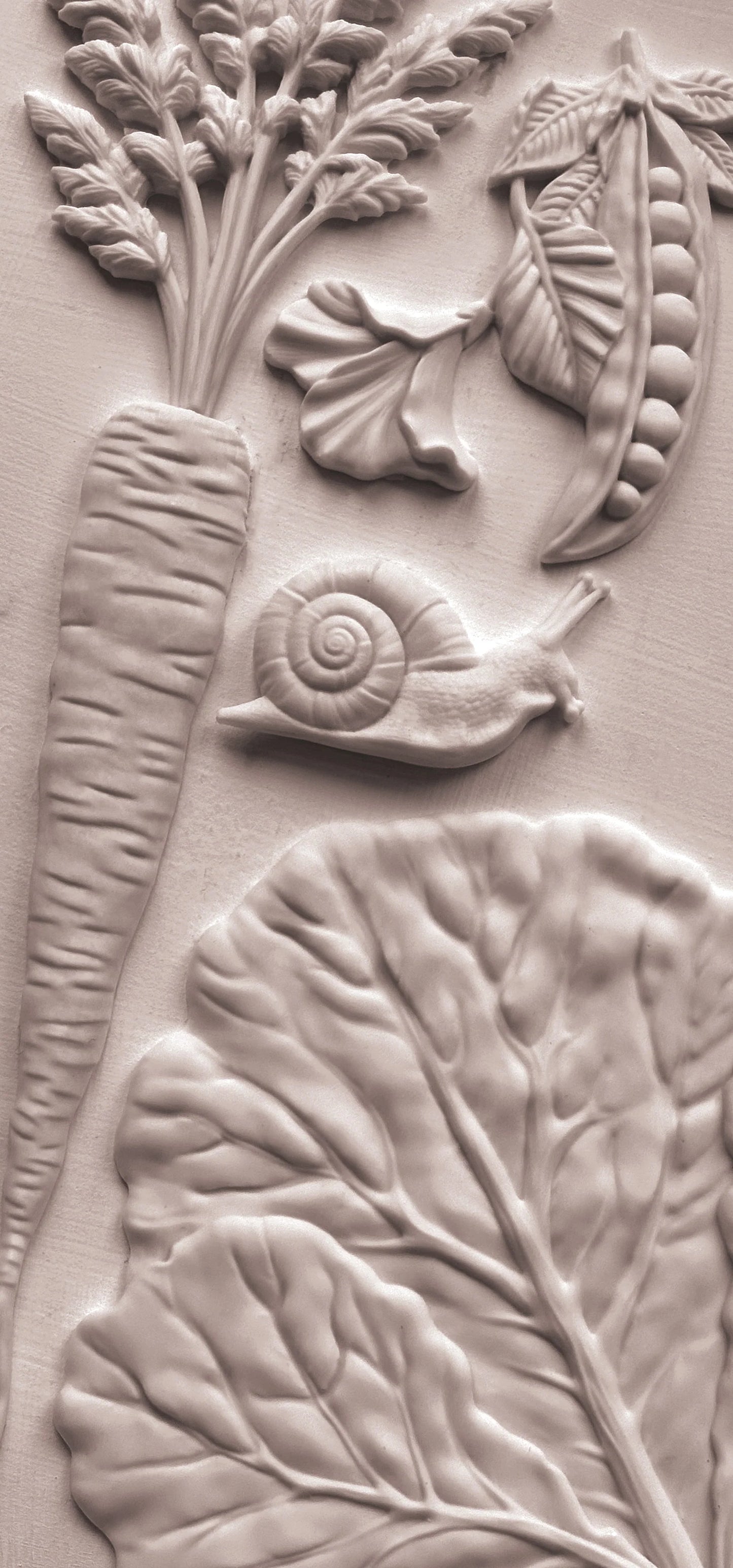 Close-up of a textured pieces with floral and vegetable designs.