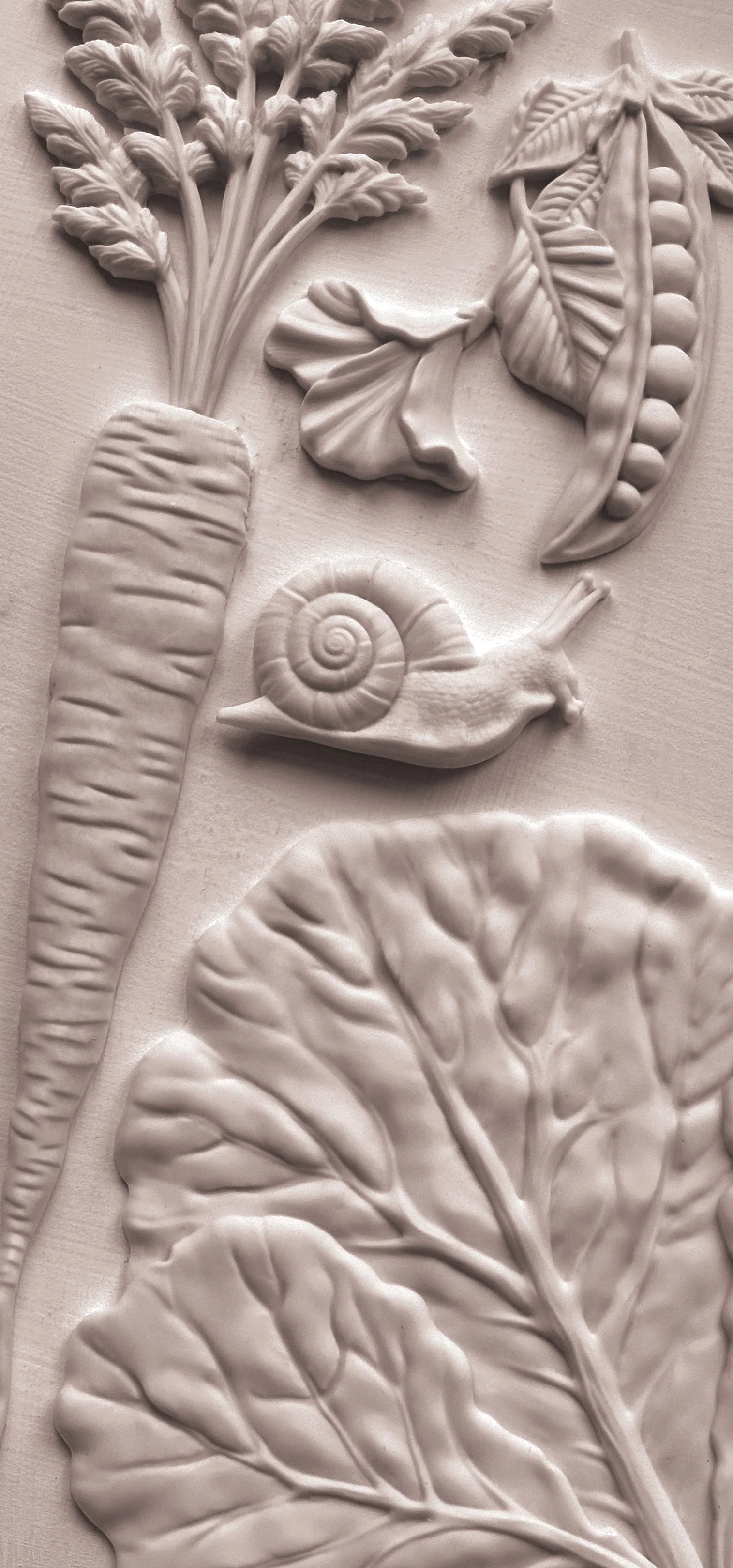 Close-up of a textured pieces with floral and vegetable designs.