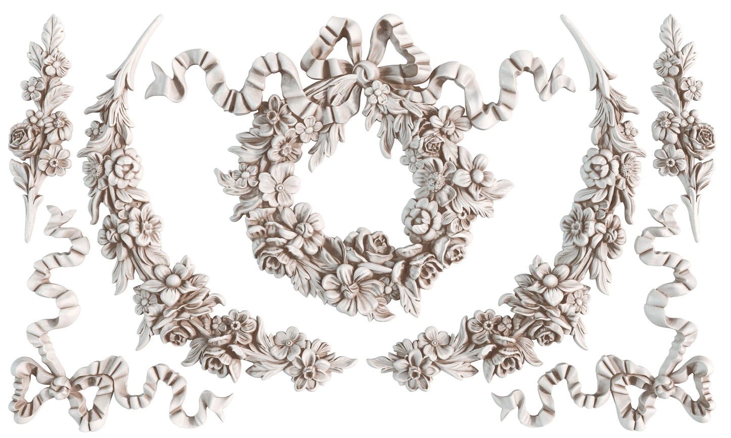 Decorative floral and ribbon molds on a white background