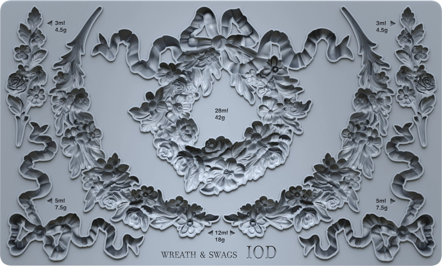 Decorative mold with wreath and swag designs on a gray background