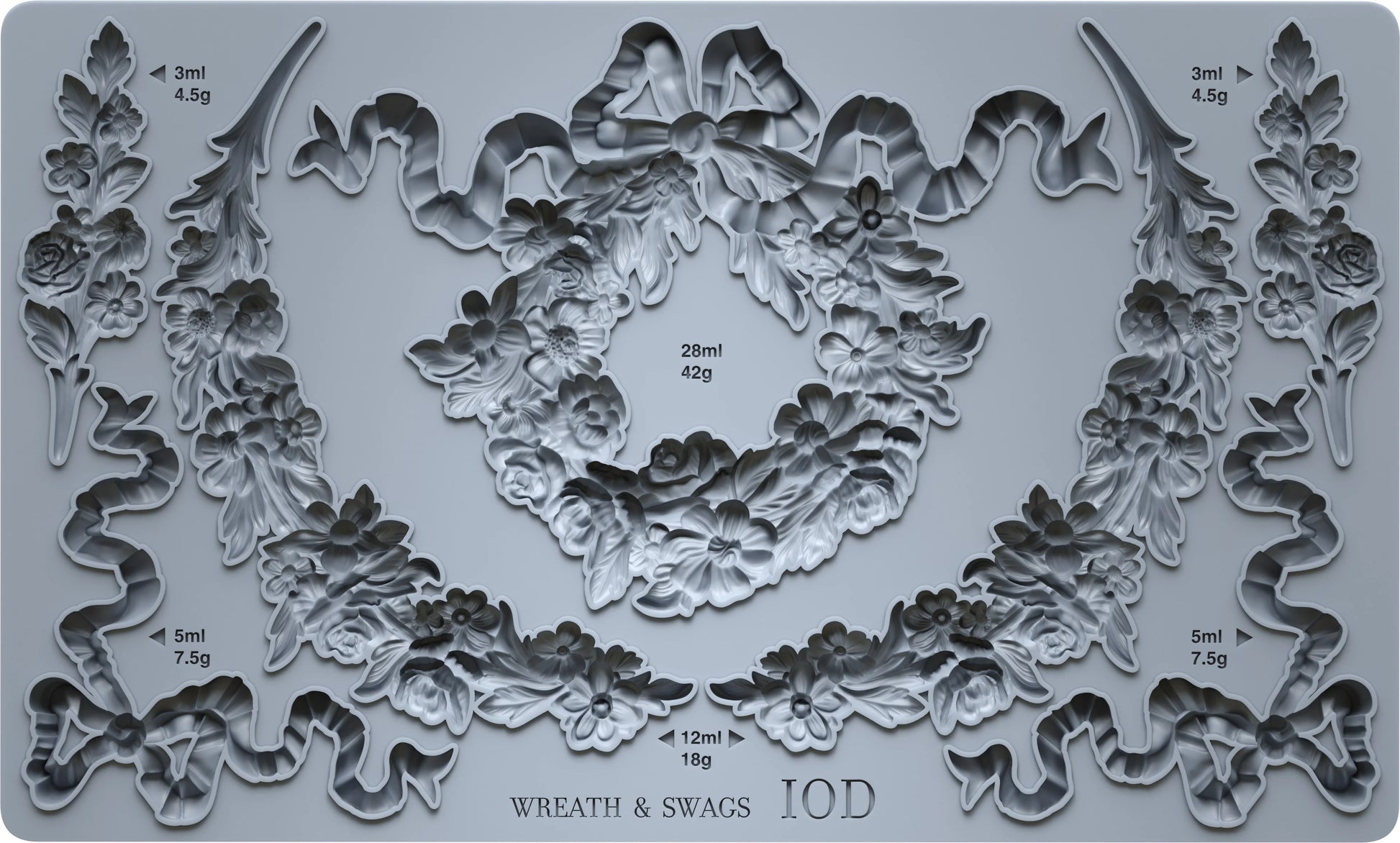 Decorative mold with wreath and swag designs on a gray background