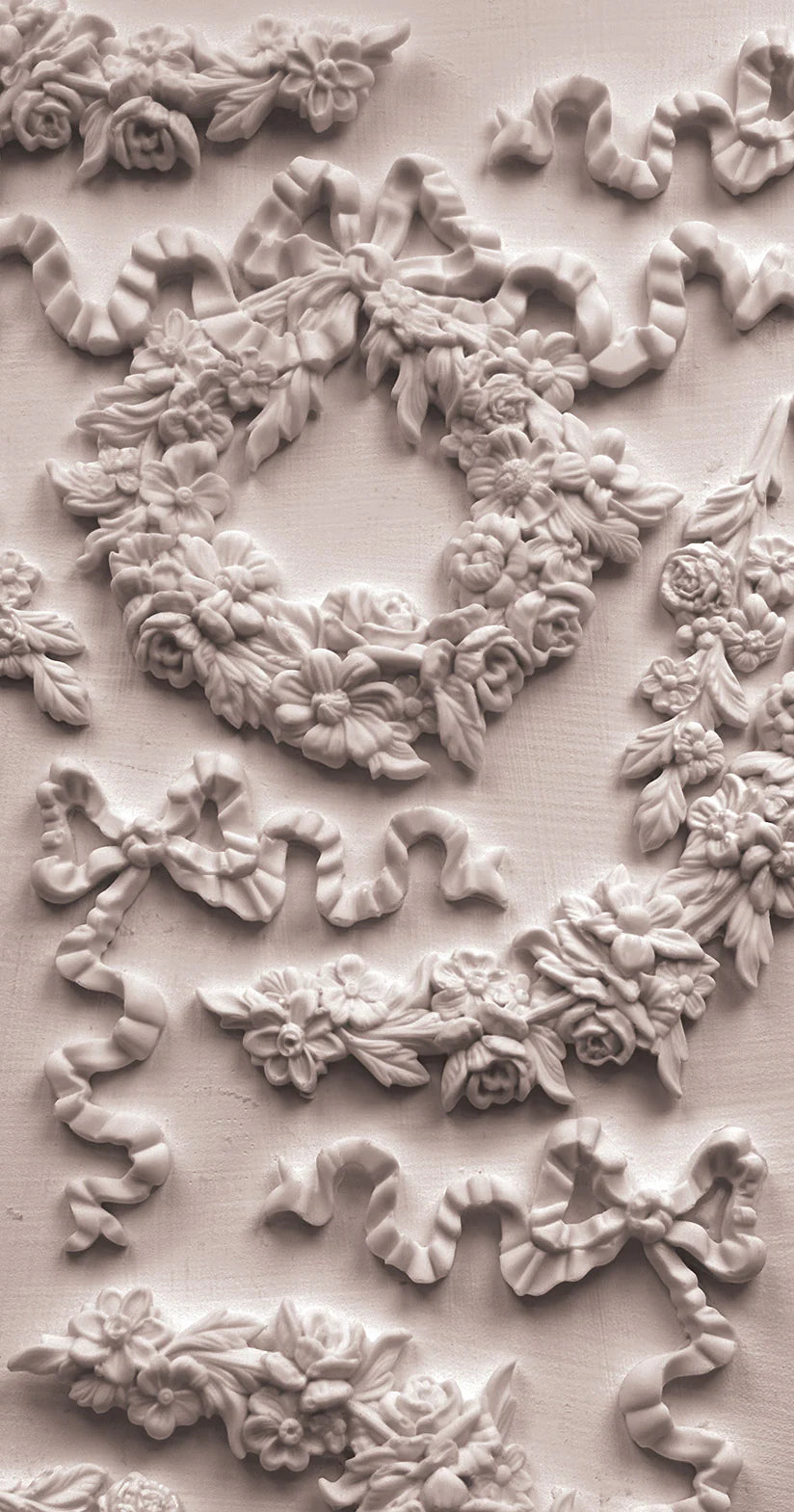 Decorative floral and leaf patterns in a light beige color on a textured background