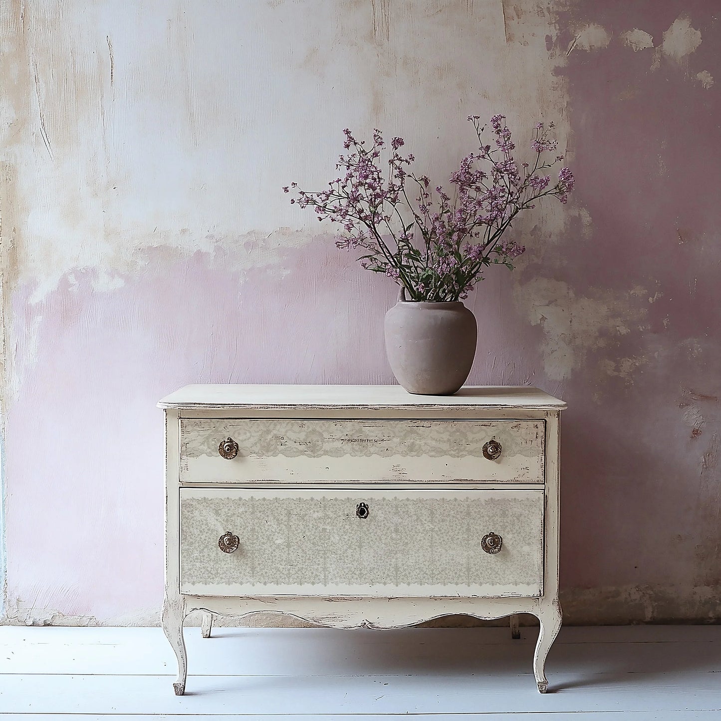 Vintage-style dresser with a vase of flowers against a textured wall.