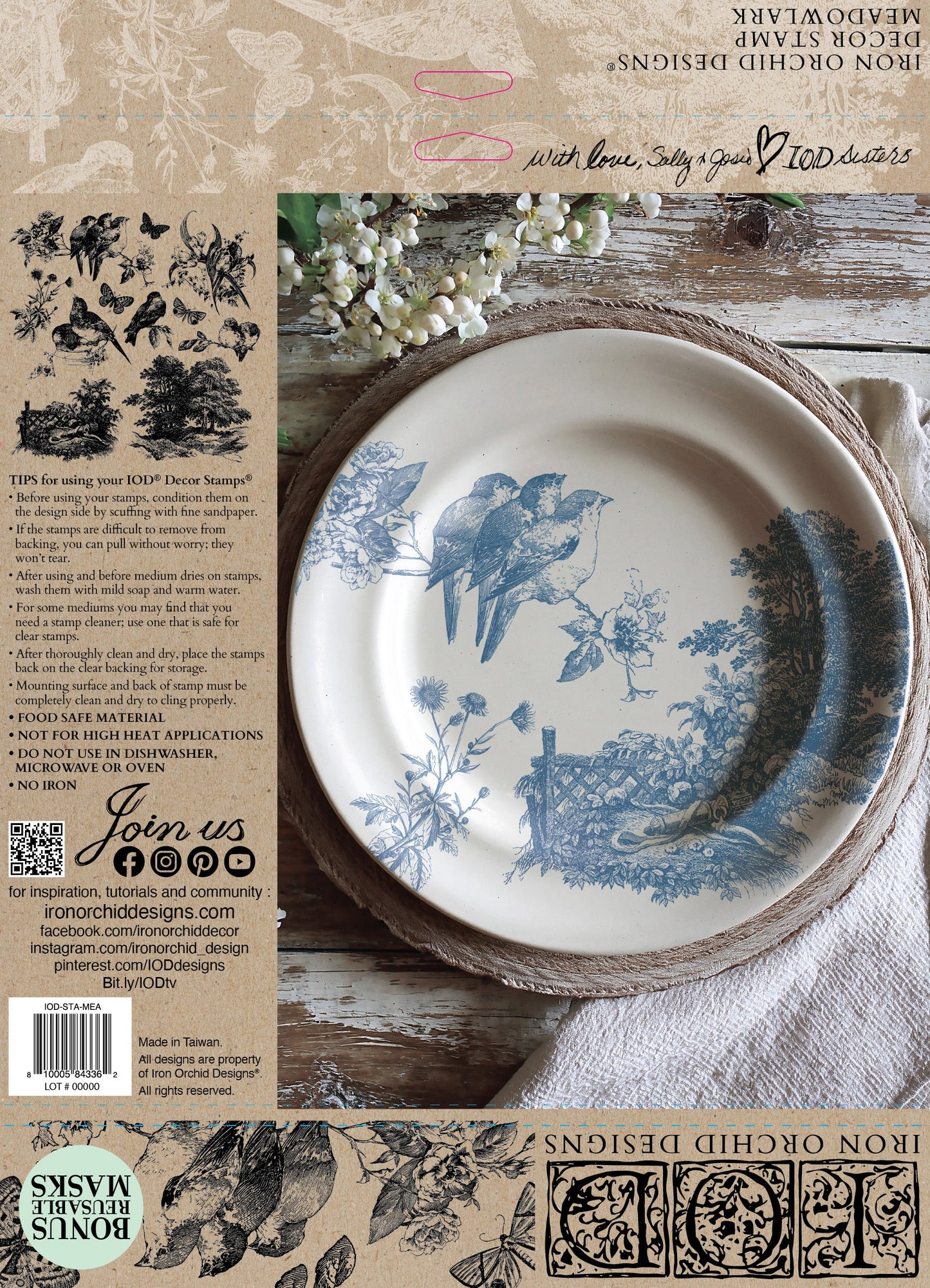 Decorative plate with bird design on a wooden surface, surrounded by rustic elements.