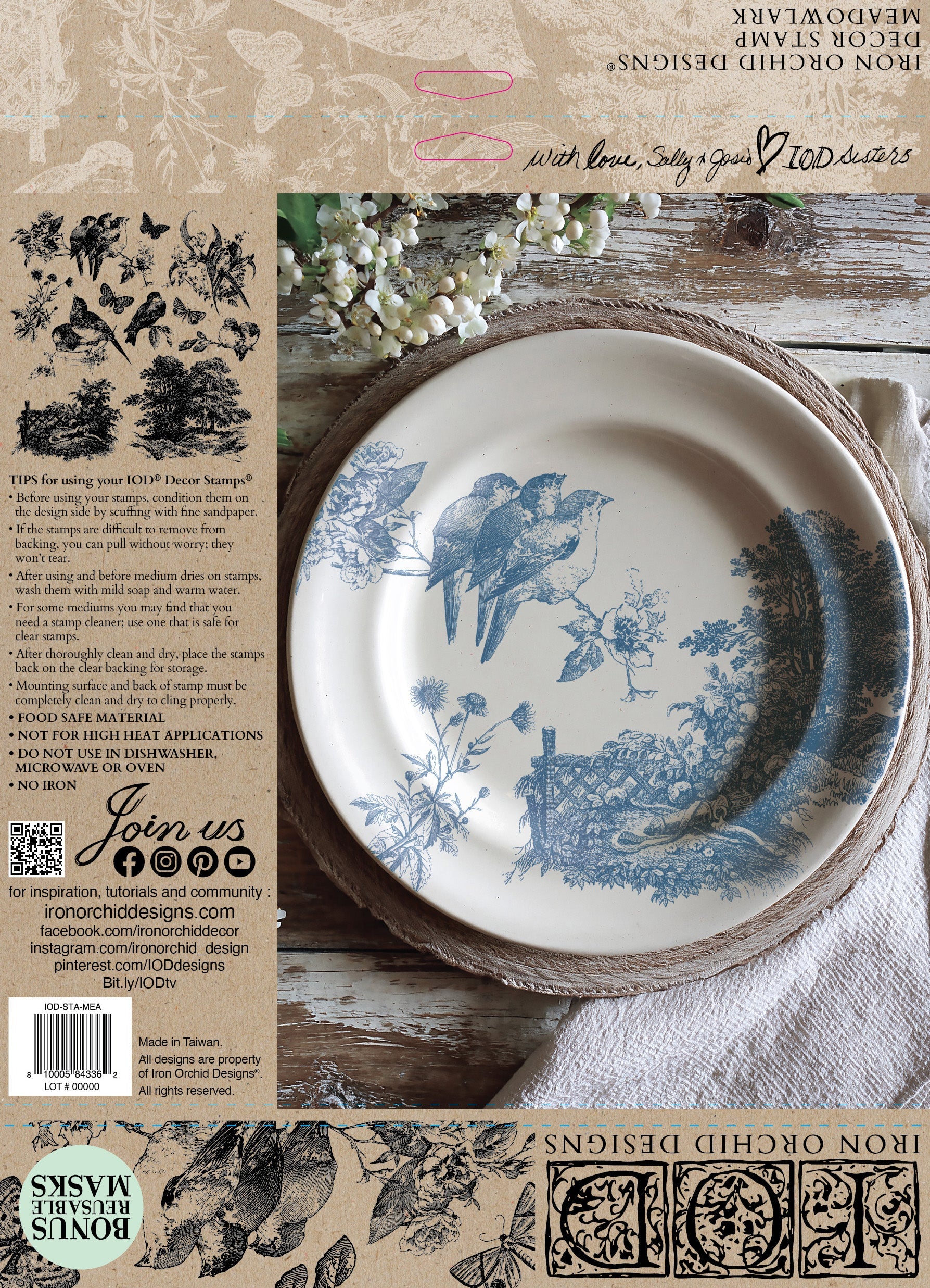 Decorative plate with bird design on a wooden surface, surrounded by rustic elements.