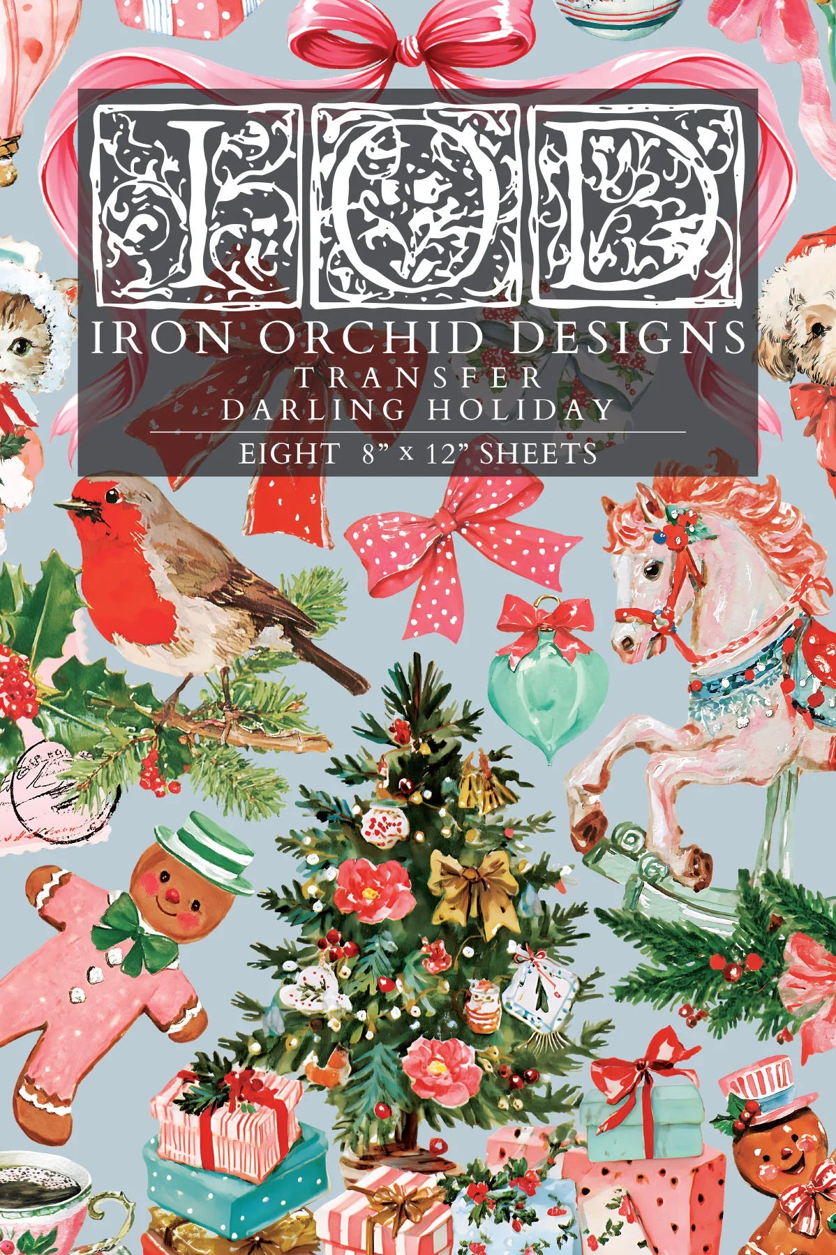 A Christmas-themed transfer paper sheet featuring a busy holiday pattern with a robin, carousel horse, ornaments, gifts, gingerbread men, bows, and a central title panel reading 'Iron Orchid Designs Transfer Darling Holiday' and 'Eight 8" x 12" sheets'.