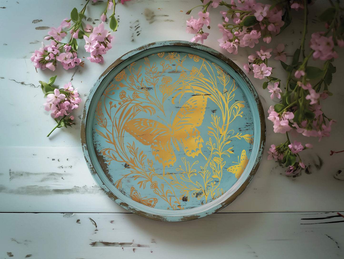 Decorative plate with butterfly design on a white surface with pink flowers