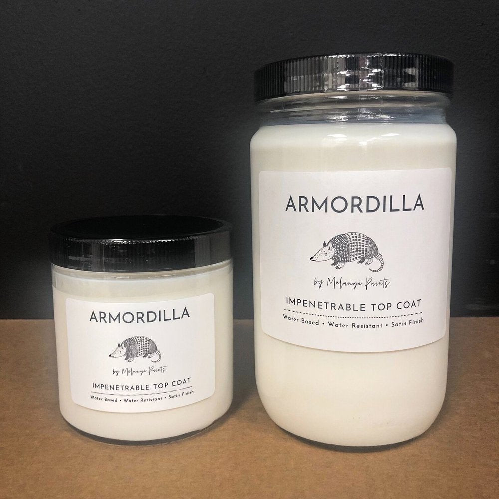 Two jars of Armordilla paint on a dark background