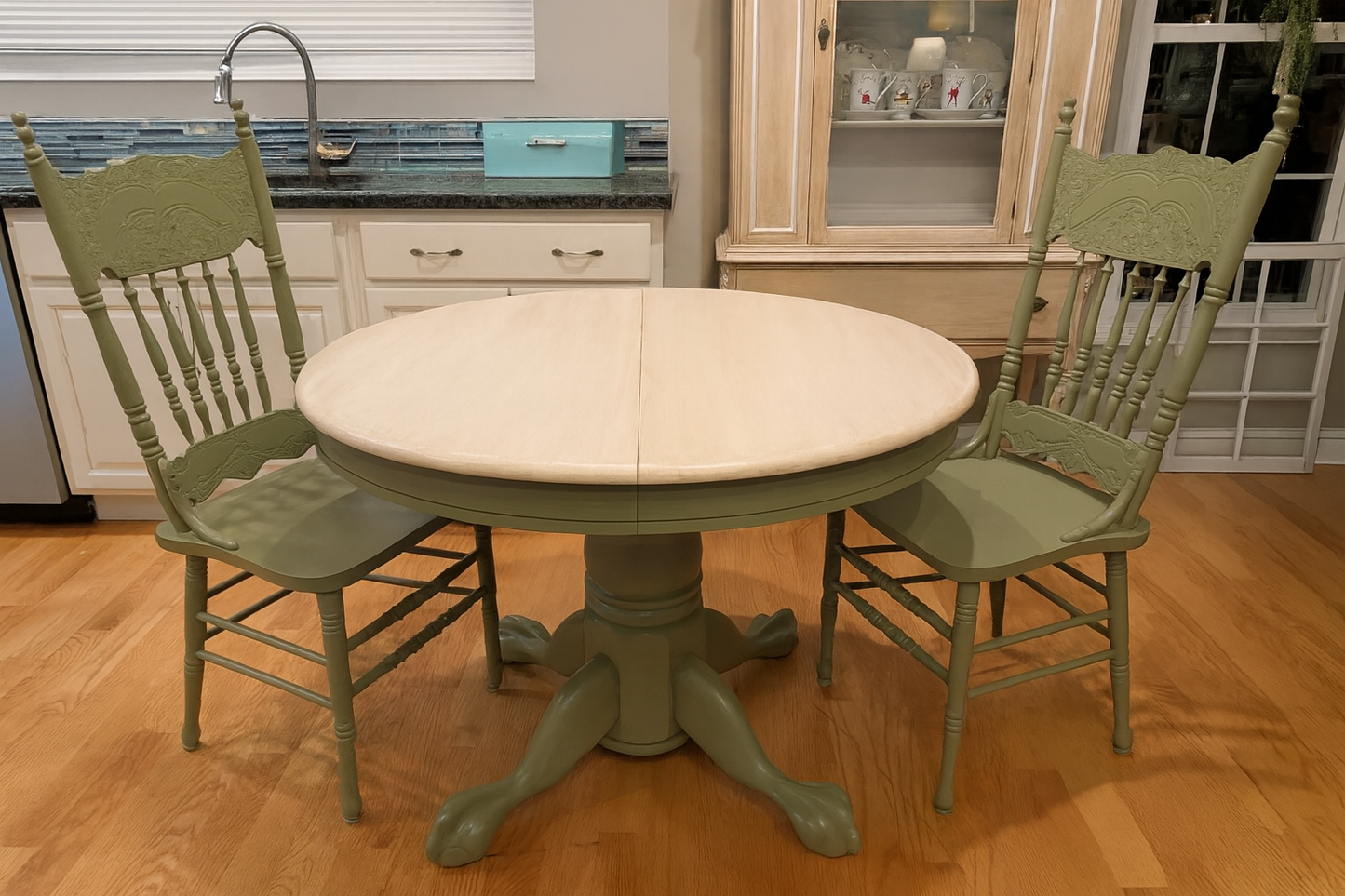 Round kitchen table with green chairs in a home setting